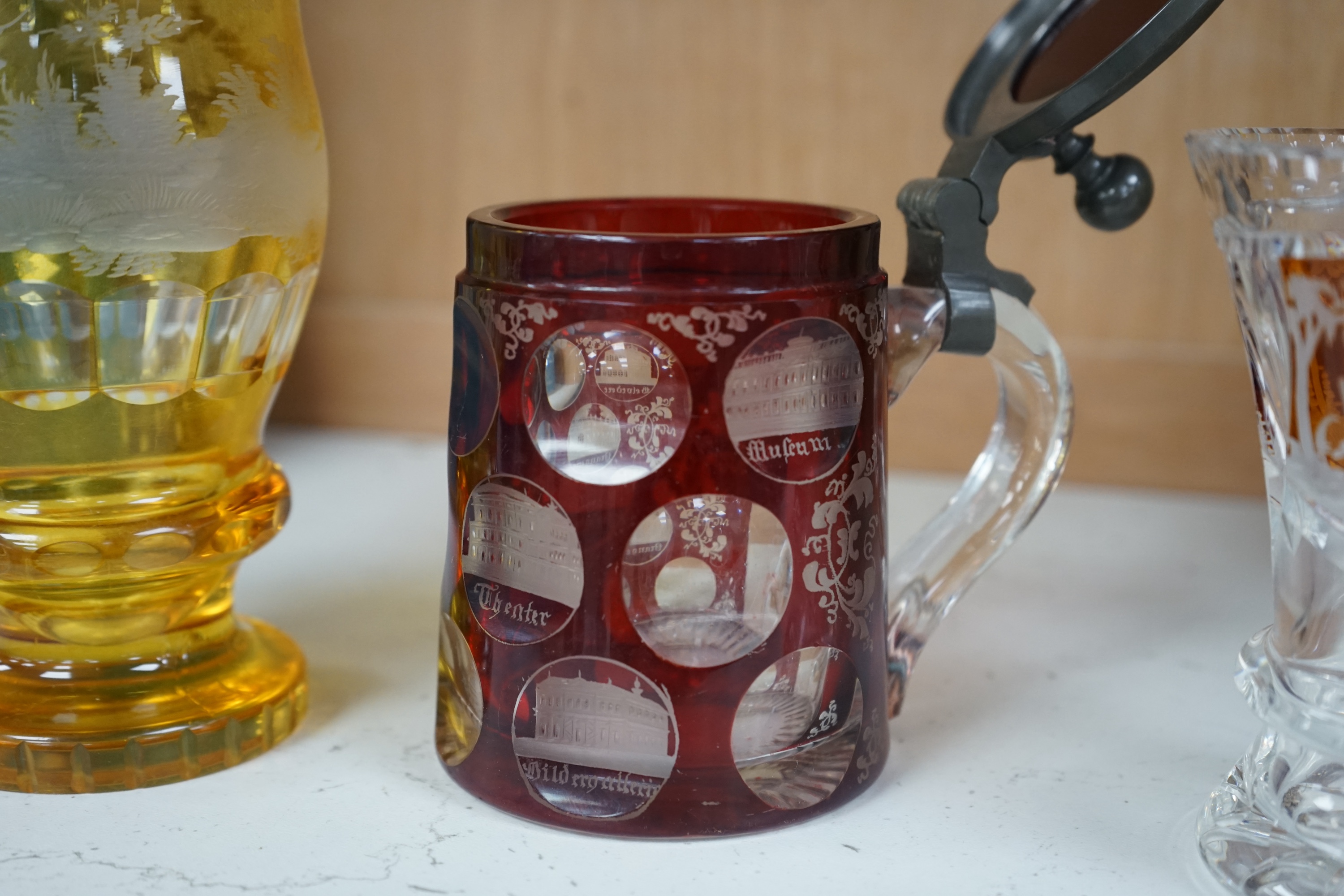 Two 19th century Bohemian glasses and a similar tankard, amber glass 15cm high. Condition - good